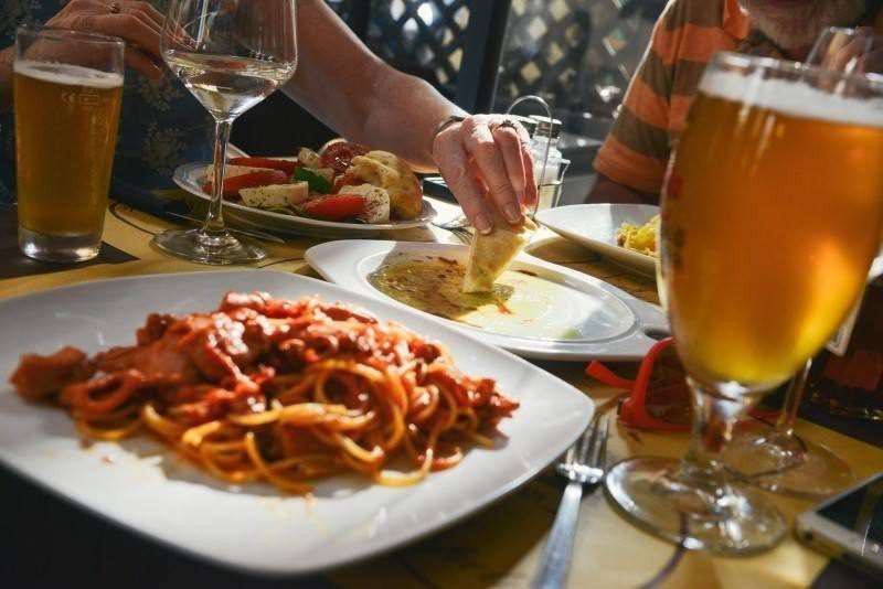 Spaghetti and beer on table in restaurant