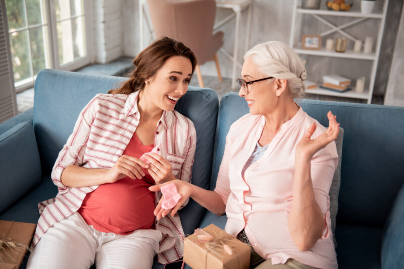 Caring future grandmother wearing glasses making nice presents