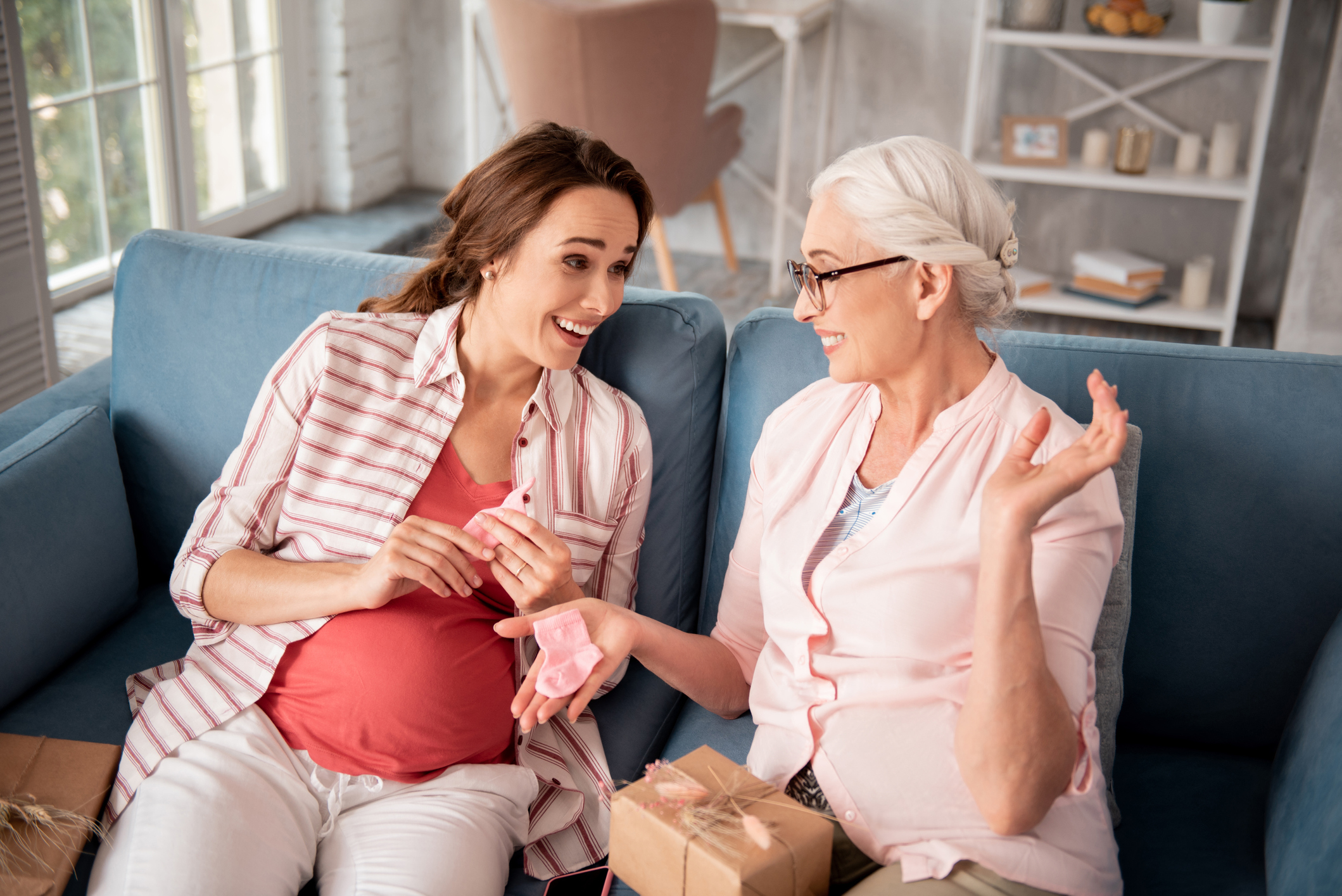 Caring future grandmother wearing glasses making nice presents