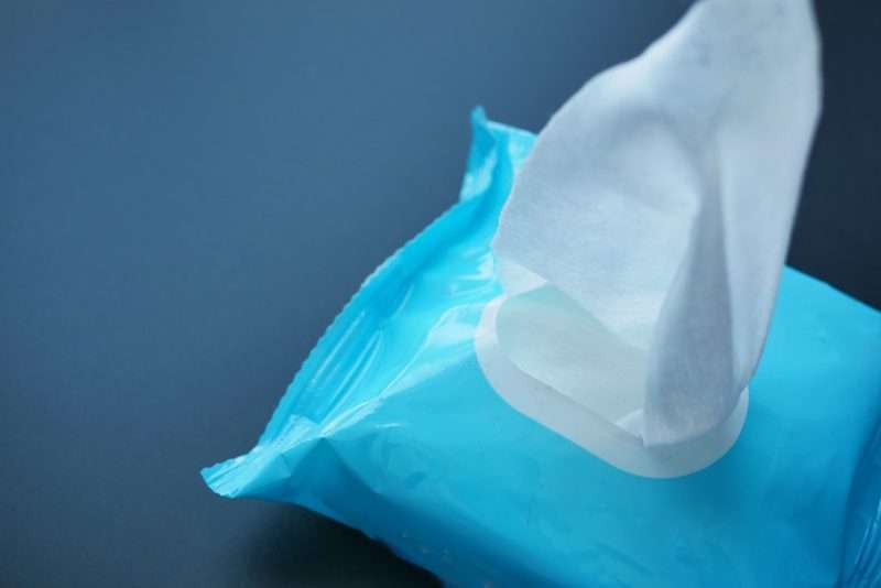 Cleansing wet wipes on table with copy space